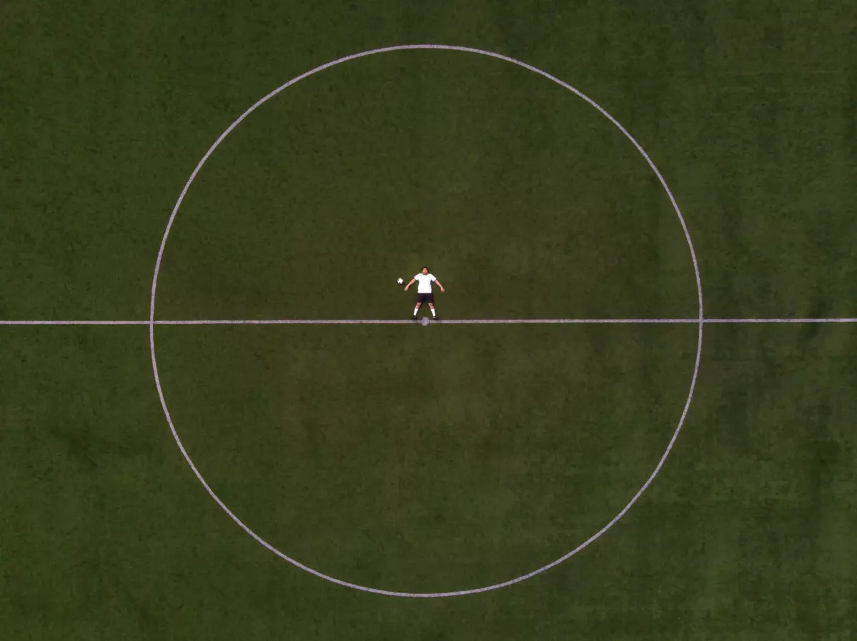soccer-player-laying-in-the-center-circle